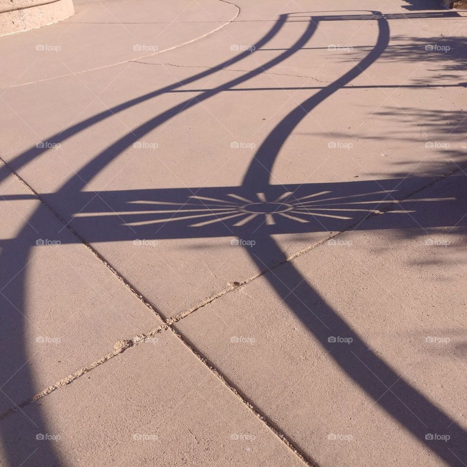 curving shadow lines on sidewalk from handrails at Sunset Point rest stop Arizona