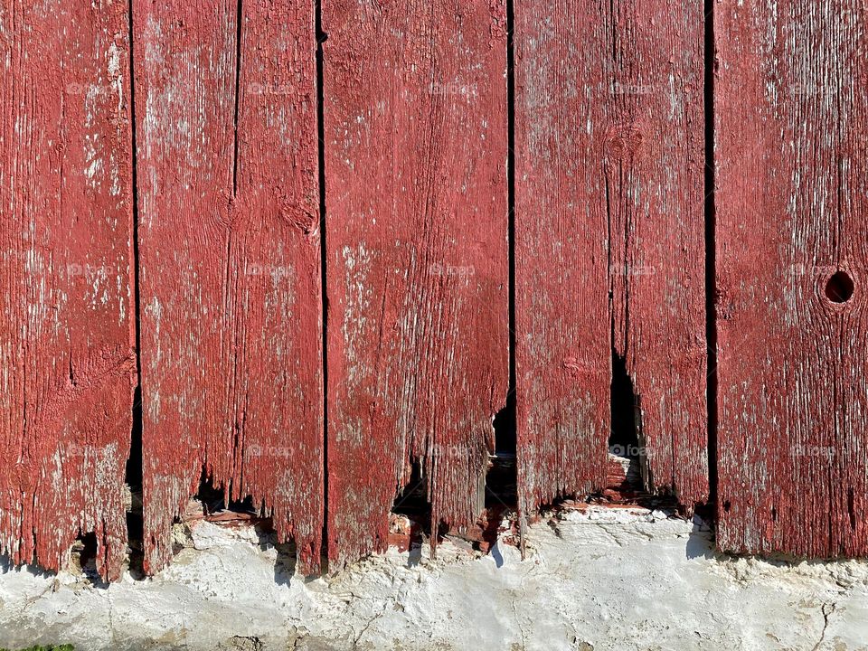 The side of an old red barn
