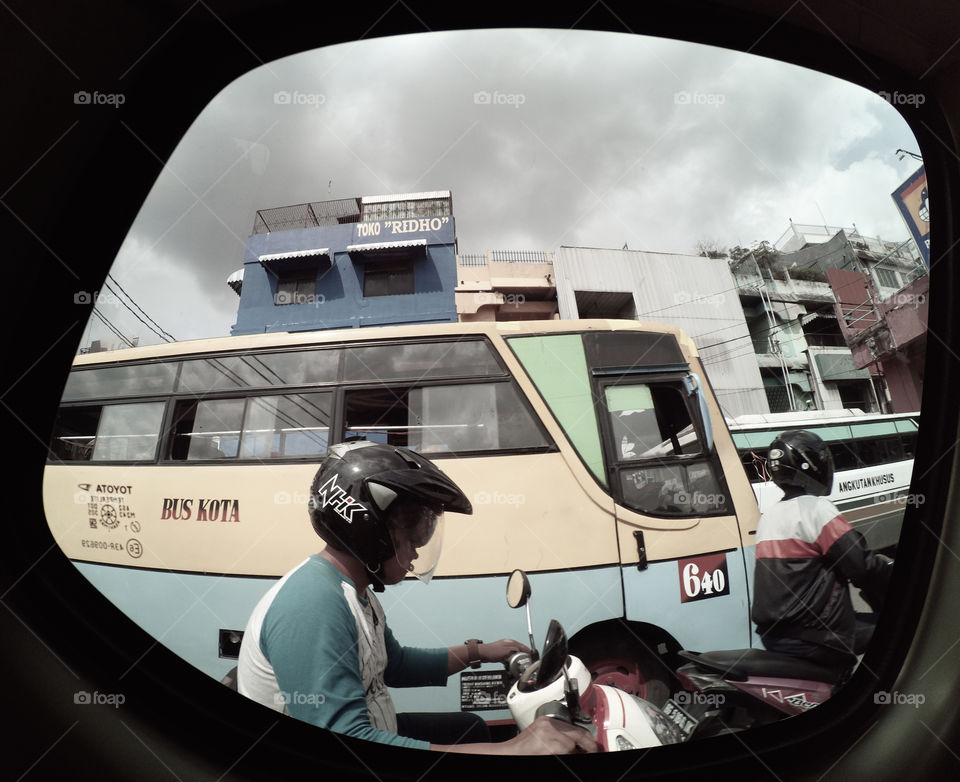 A Man and a Bus Caught from Car Window Frame in Traffic Jam in Palembang City South Sumatera