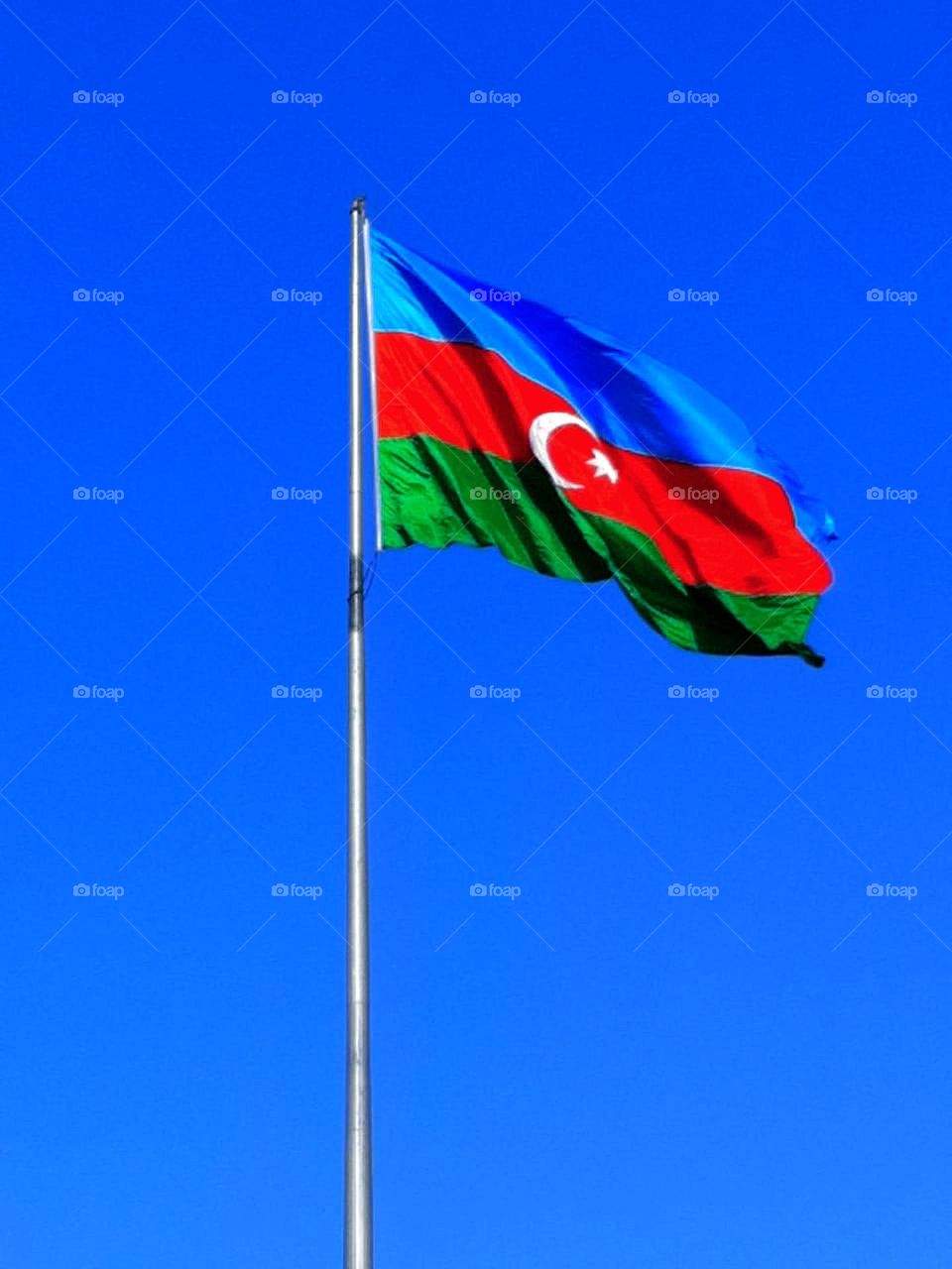 Flagpole. Azerbaijan flag against the blue sky