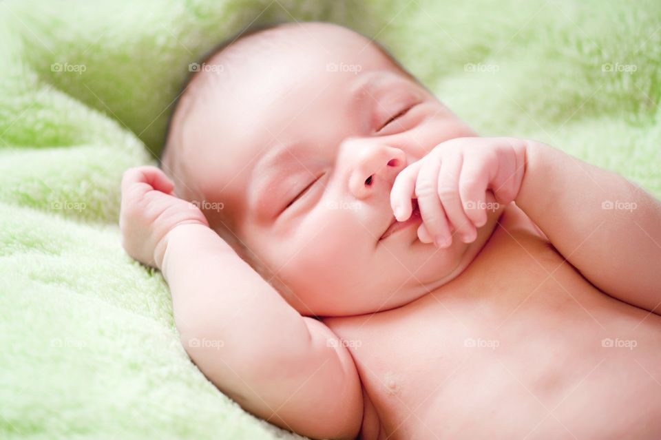 Sweet baby sleeping on bed