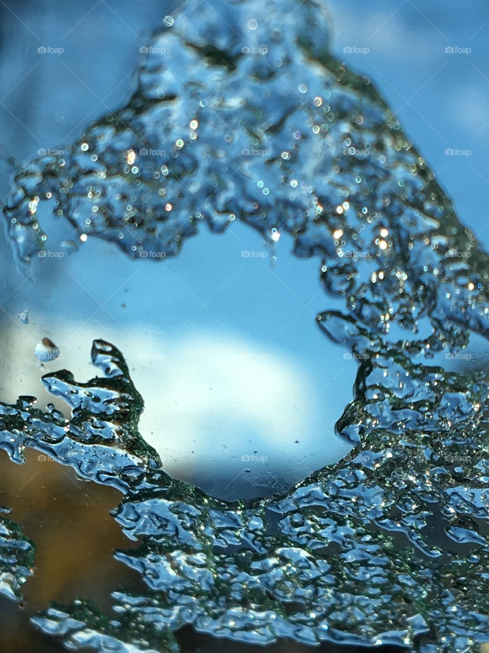 Ice formation on windshield with blue skies in background 