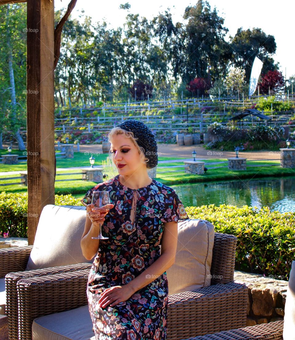 Woman sitting on couch with wine glass in hand