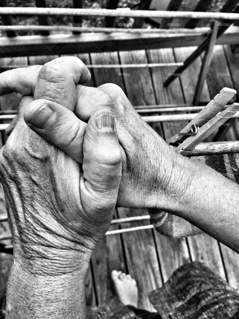 Aging hands hanging laundry