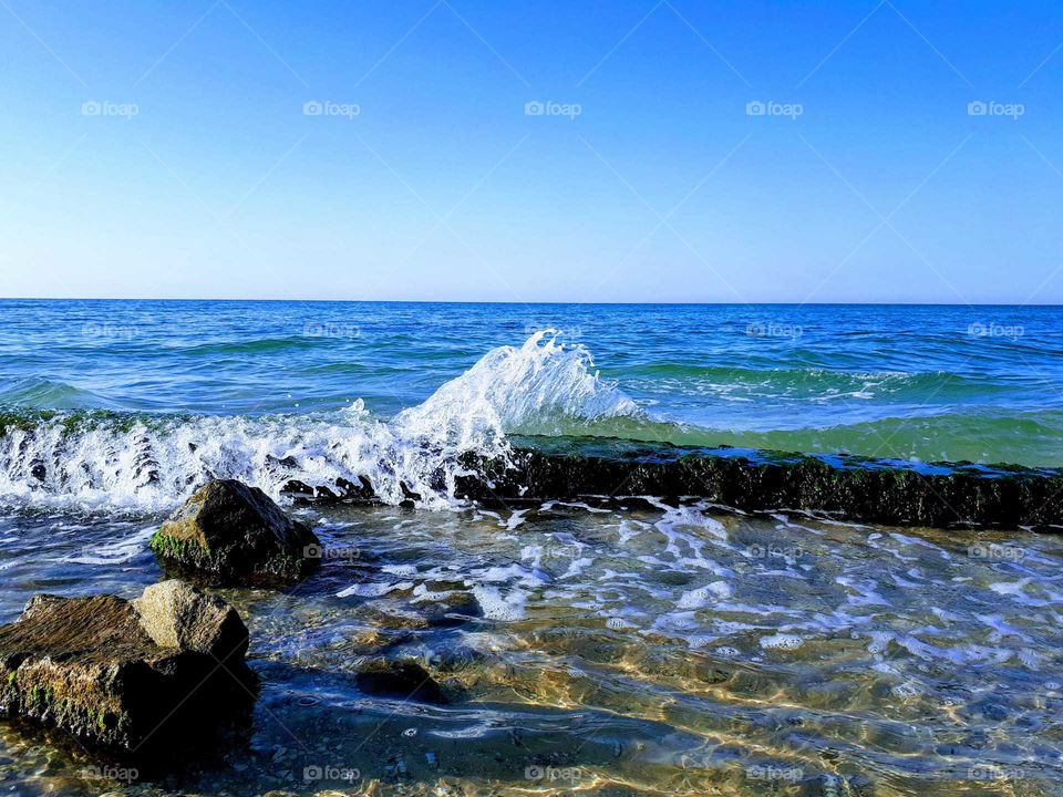 Beach with waves and seafoam