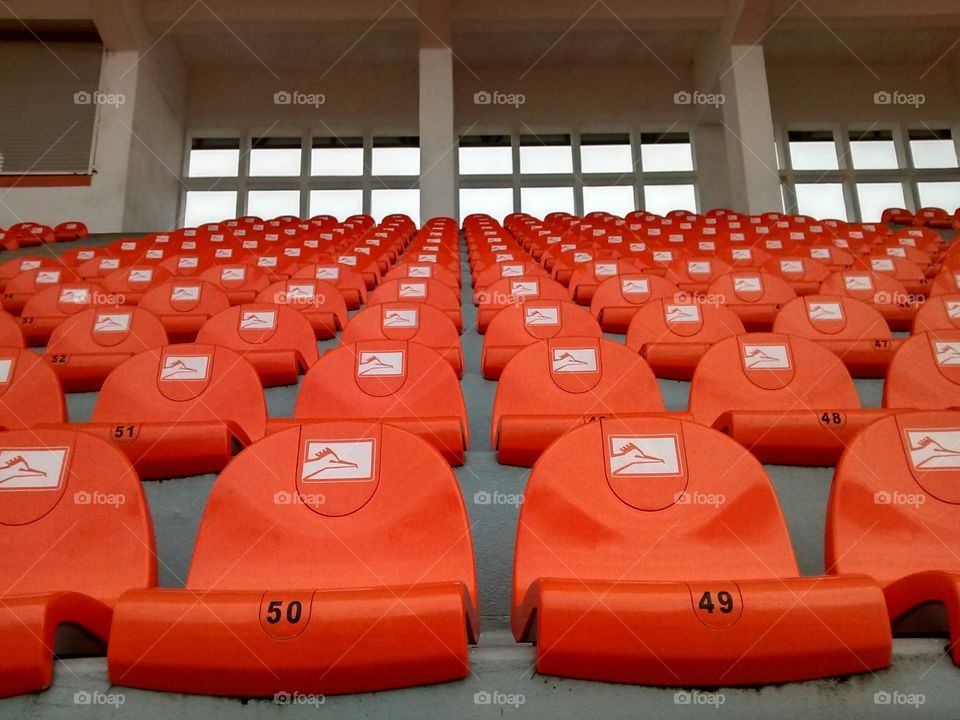 Orange stadium seats. this are some seats in a sports  stadium in my  city.