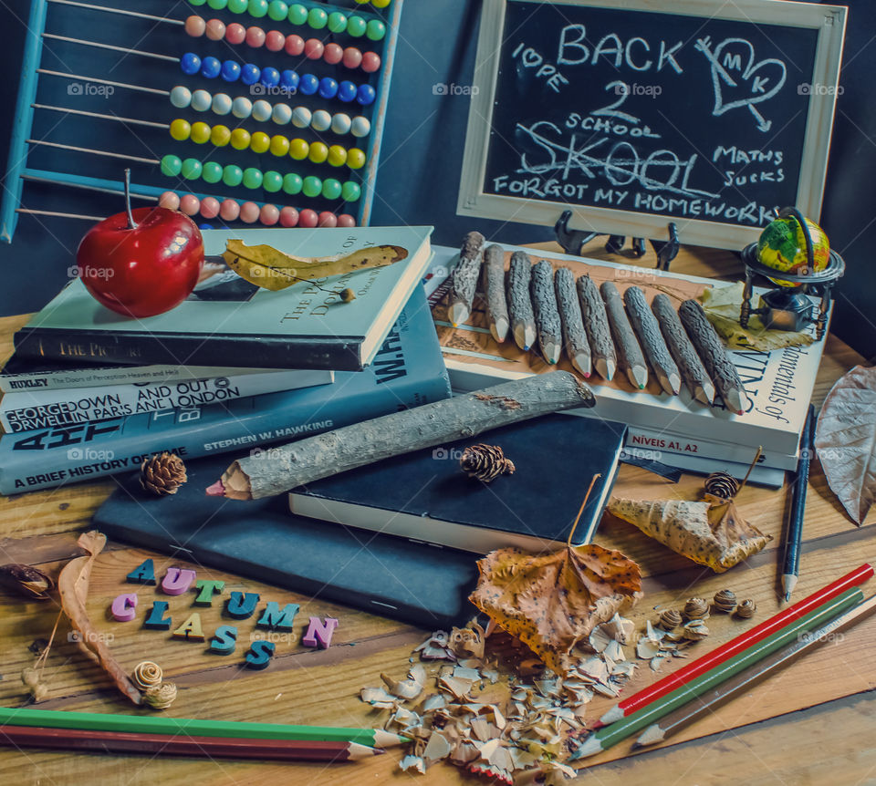 Retro back to school display for the autumn semester, featuring text books, twig pencils, abacus, and a graffitied chalk board
