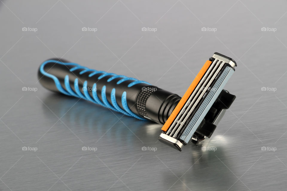 Razor close up on brushed steel background