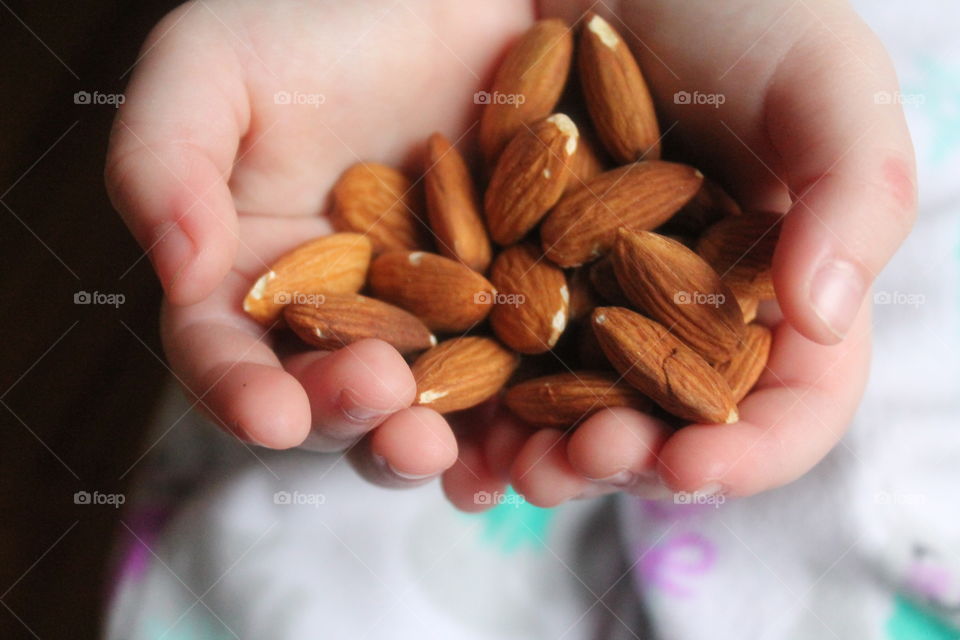 Child holding almonds