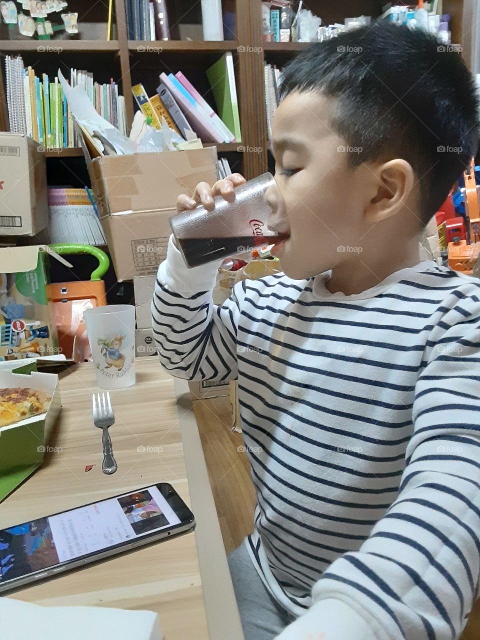 a busy boy with coca cola on his mouth