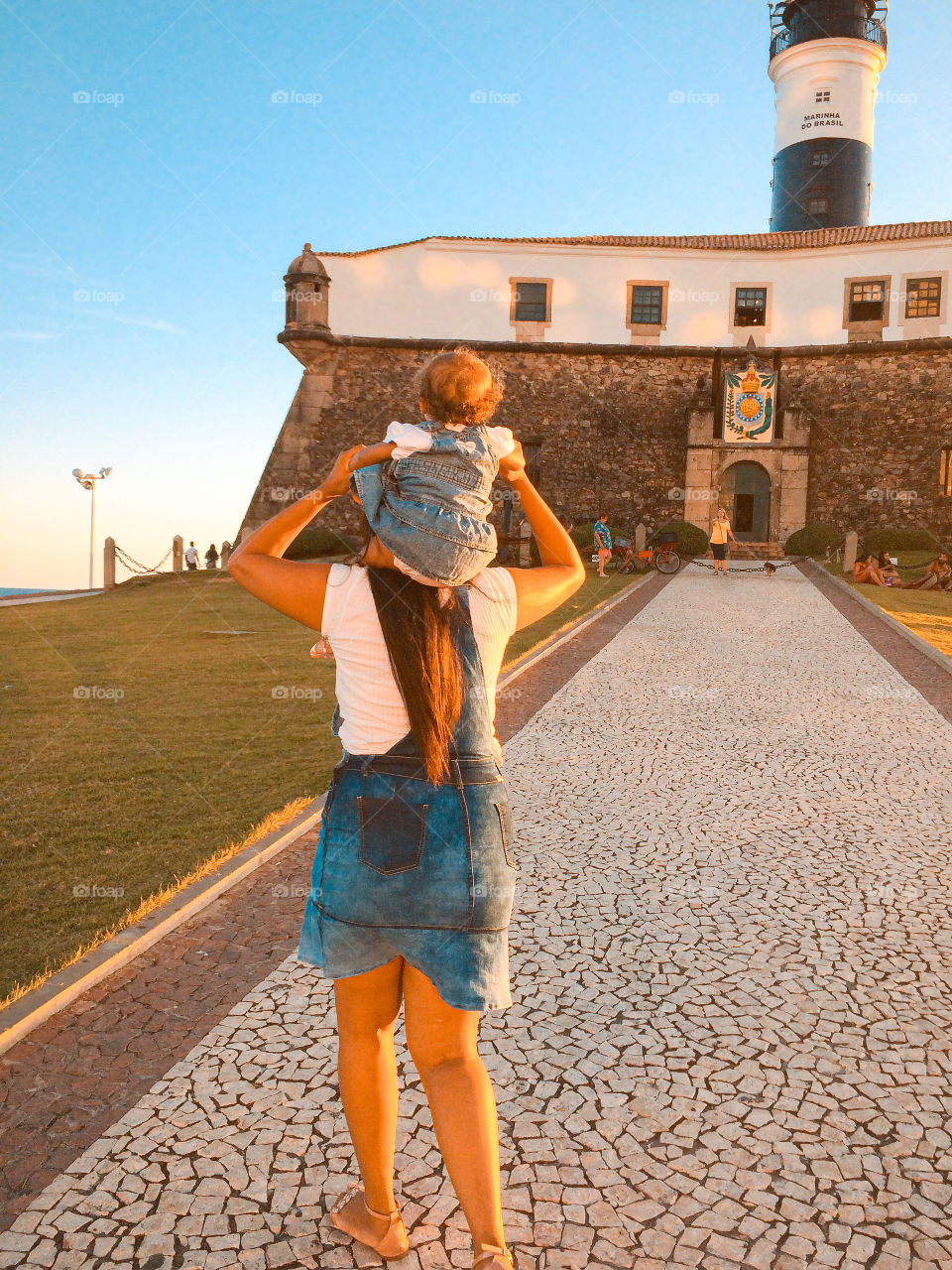 Most beautiful thing, mother and daughter strolling at the bar lighthouse in salvador Bahia Brazil