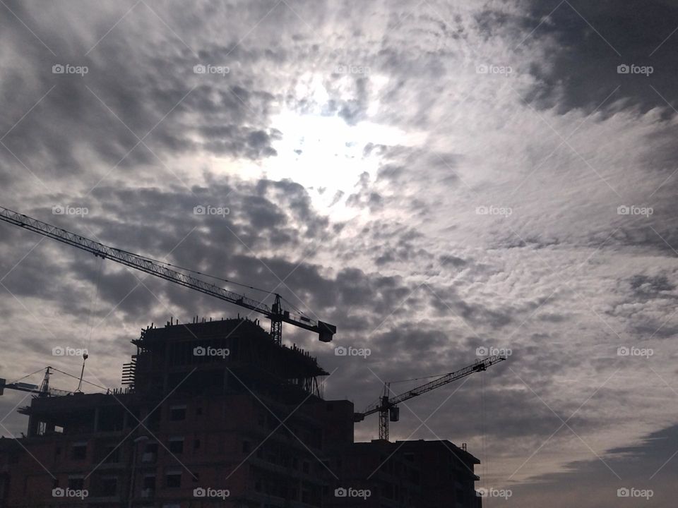 Building construction and cloudy sky