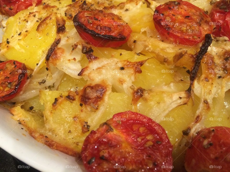 Roasted potatoes with tomatoes and Parmesan cheese