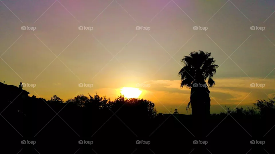 The sun like a fireball half covered by a cloud in the village of Panza on the Italian island of Ischia