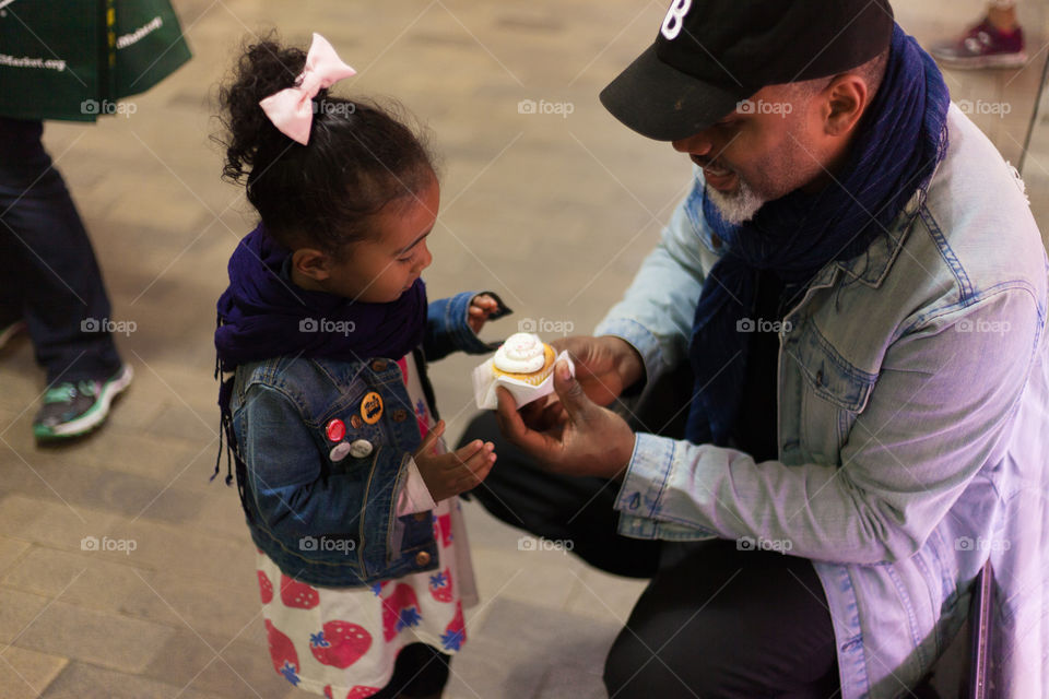 Father & Daughter Sharing A Delicious Cupcake