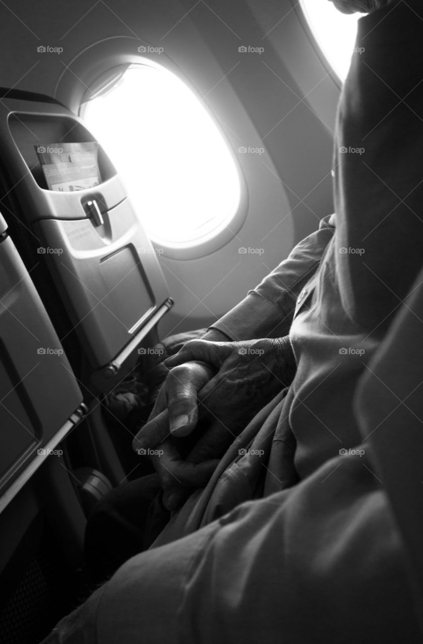 A senior couple . Holding hands at a plane.