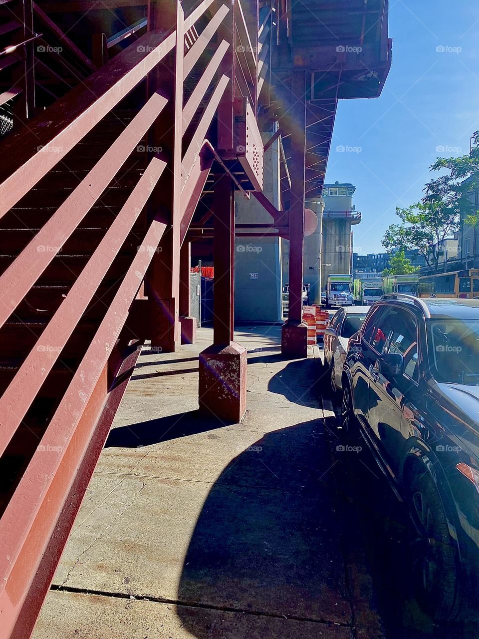 The „Pulaski Bridge“ in LIC, Queens is one of my favorite places to photograph. Its modern architecture, the red metal staircase with parallel lines are all very photogenic especially when enhanced with shadows. 2023. Hypnotic Productions