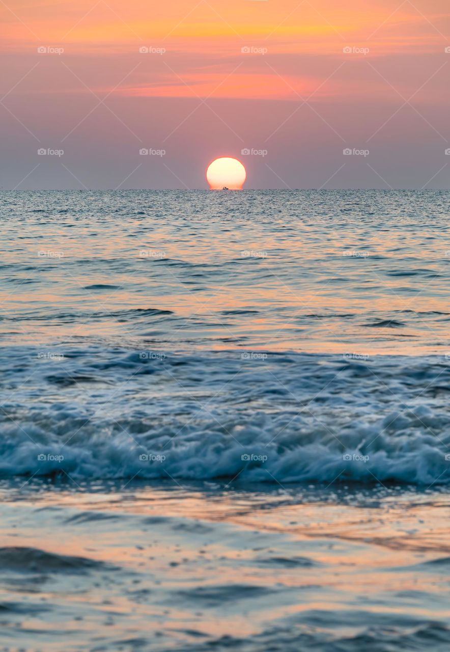 Omega scene of sunset into sea