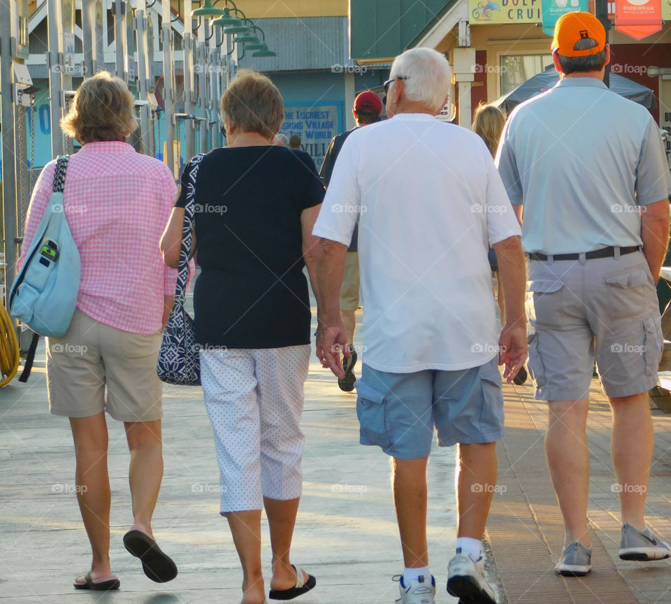 Catching a breath of fresh air and enjoying the sights, these elderly couples do this to benefit their exercise!