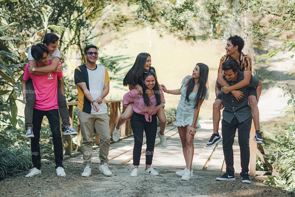 Group of friends enjoying together in nature in time of social estating