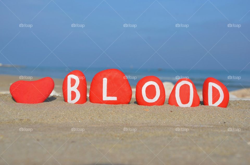concept of blood on red stones on the beach