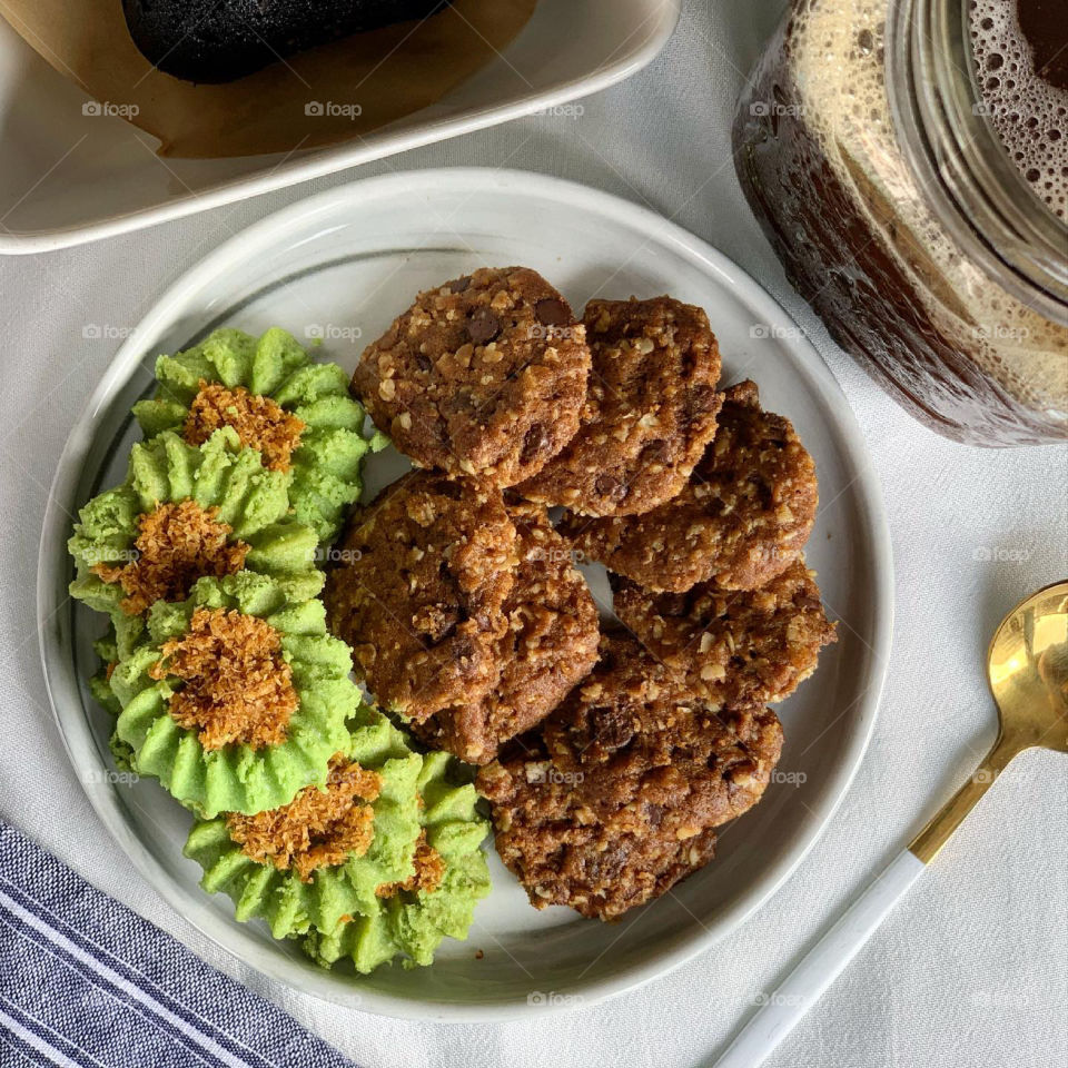 Afternoon snacks ondeh cookies and chocolate chip oat cookies with black brownie and sea salt and ice cold black coffee