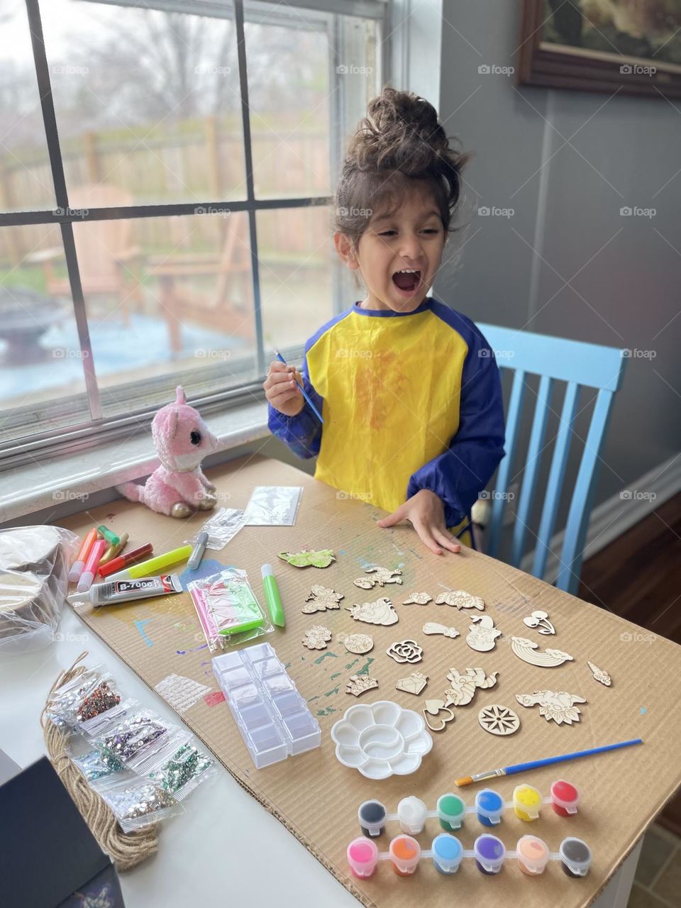 Little girl amazed at all the arts and crafts, painting with mommy, using Santa’s gifts, making crafts with kids 