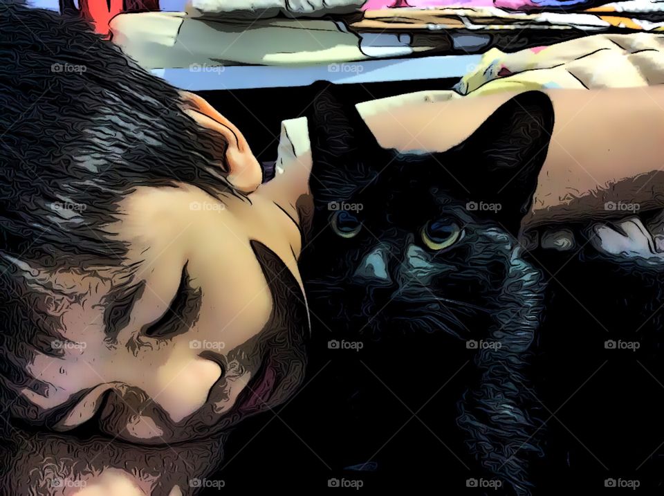 Close-up of boy sleeping with black cat
