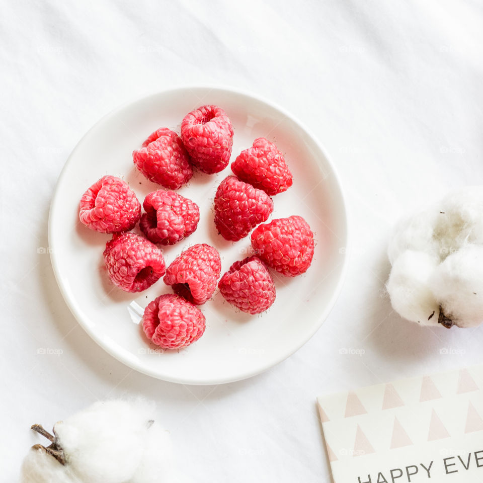 Fresh raspberry on white plate 