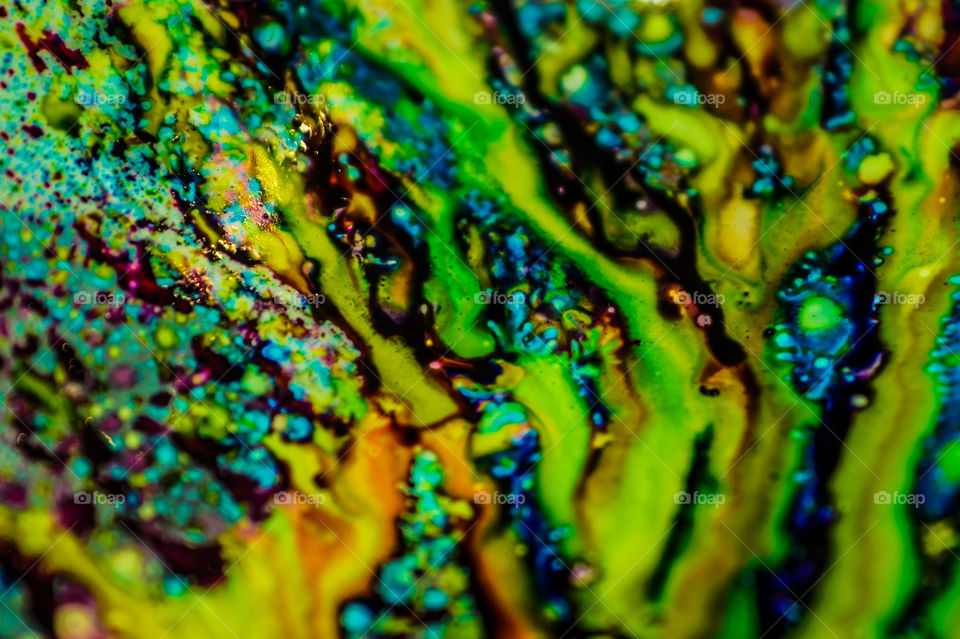 The ink to refill the printer cartridge was spilled onto the white washbasin and the paints blended into abstract drips and patterns.