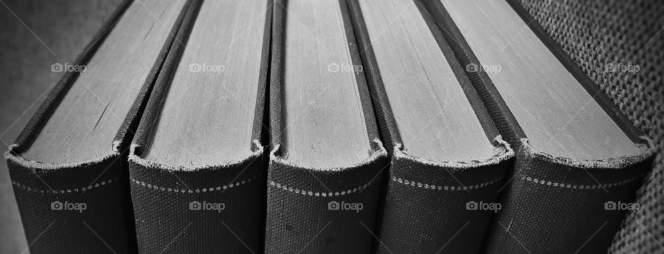 Detail of book spines and pages, in black and white