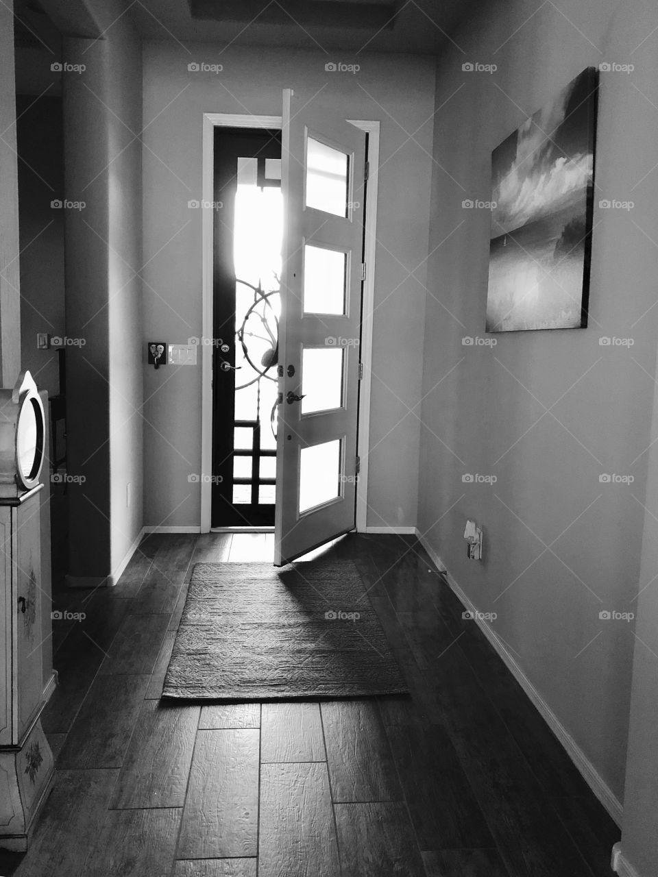 Black and white sunlight through an open entryway door