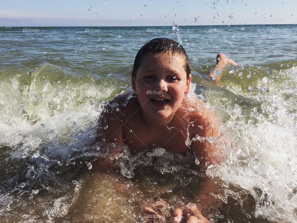 Portrait of shirtless child swimming