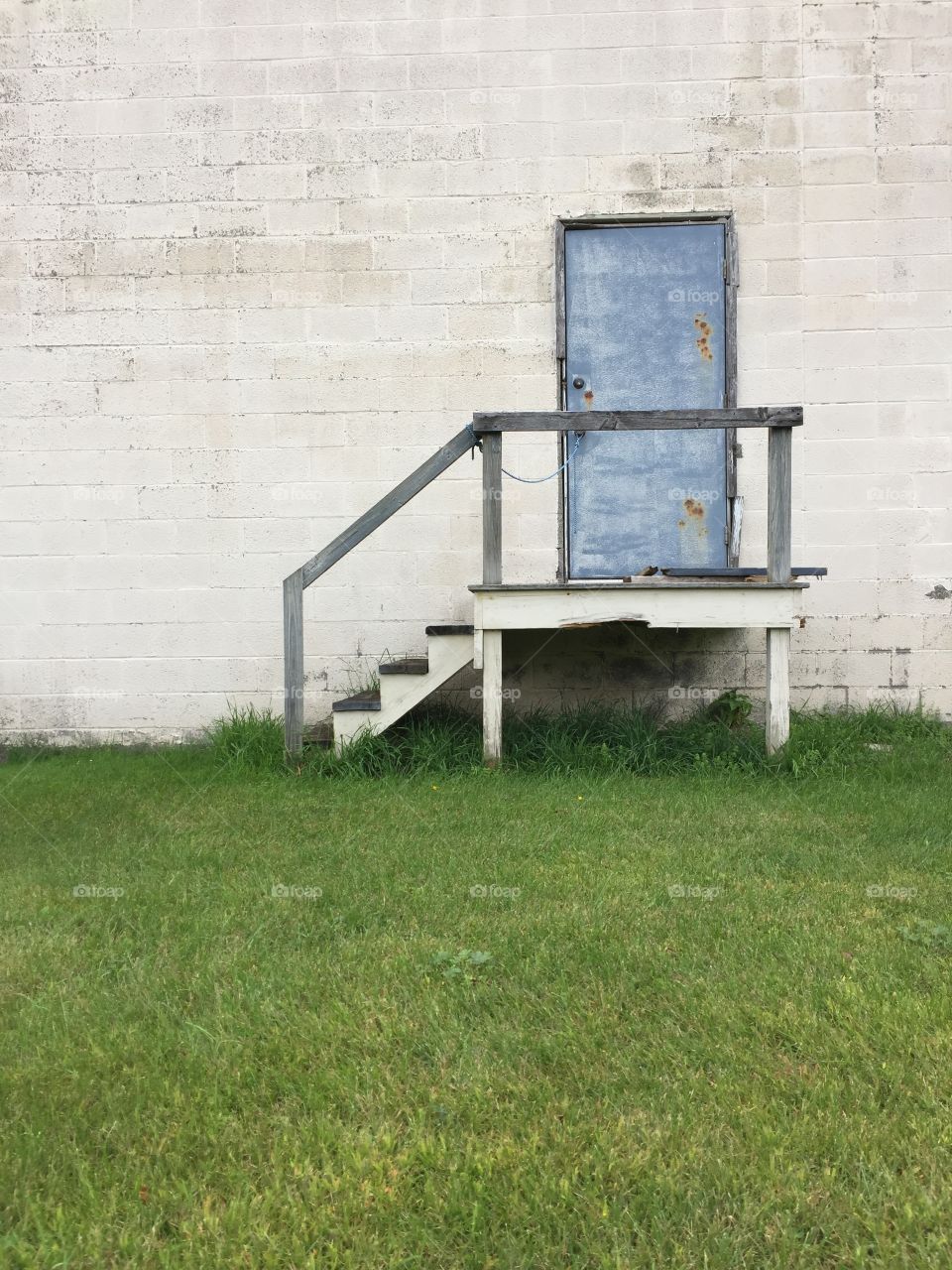 Stairs and door on the side of an old building 
