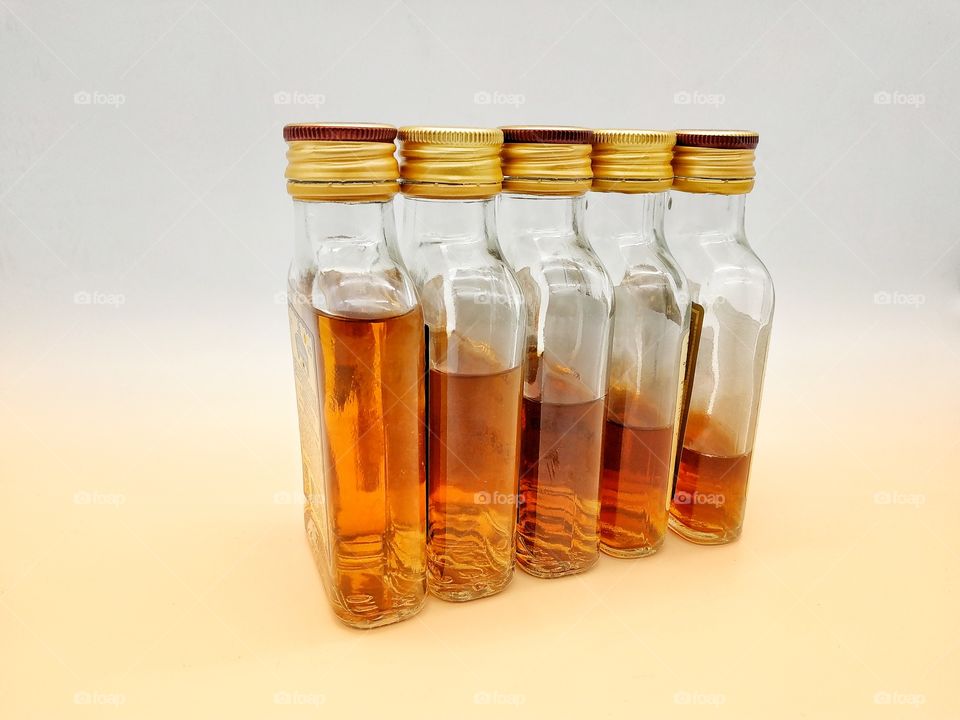 cognac bottles arranged in order of the volume of liquid drunk