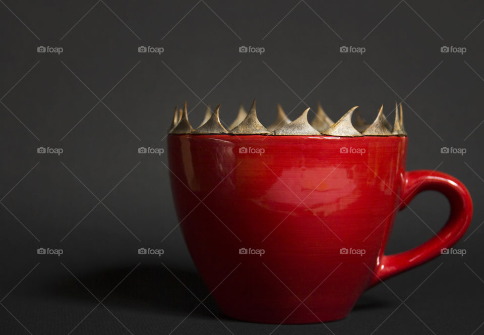 Red coffee cup with spikes on the edge