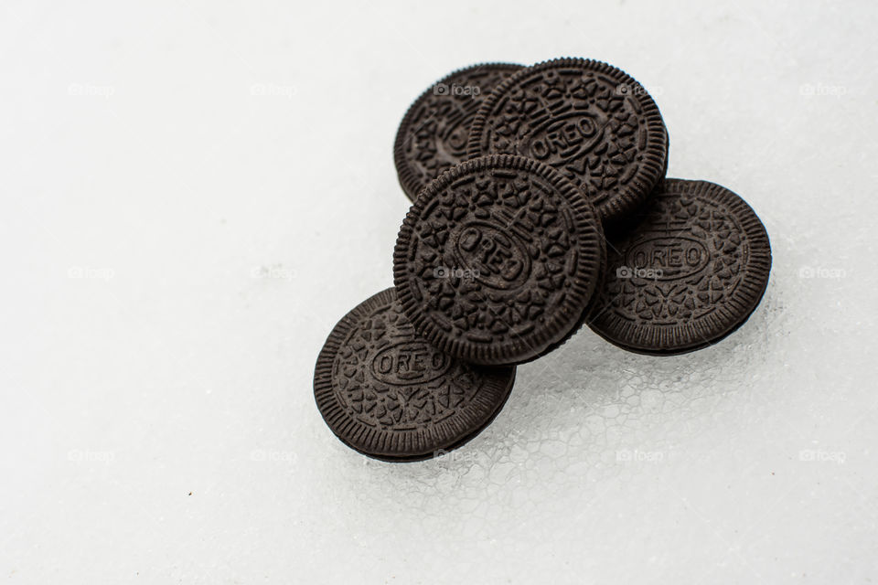 Cool Oreo Cookies artistic shot of Oreo Cookies on arctic terrain ice pieces and ice covered snow plies of fun Oreos travelling on winter background thin and thick Oreo Cookies art photography