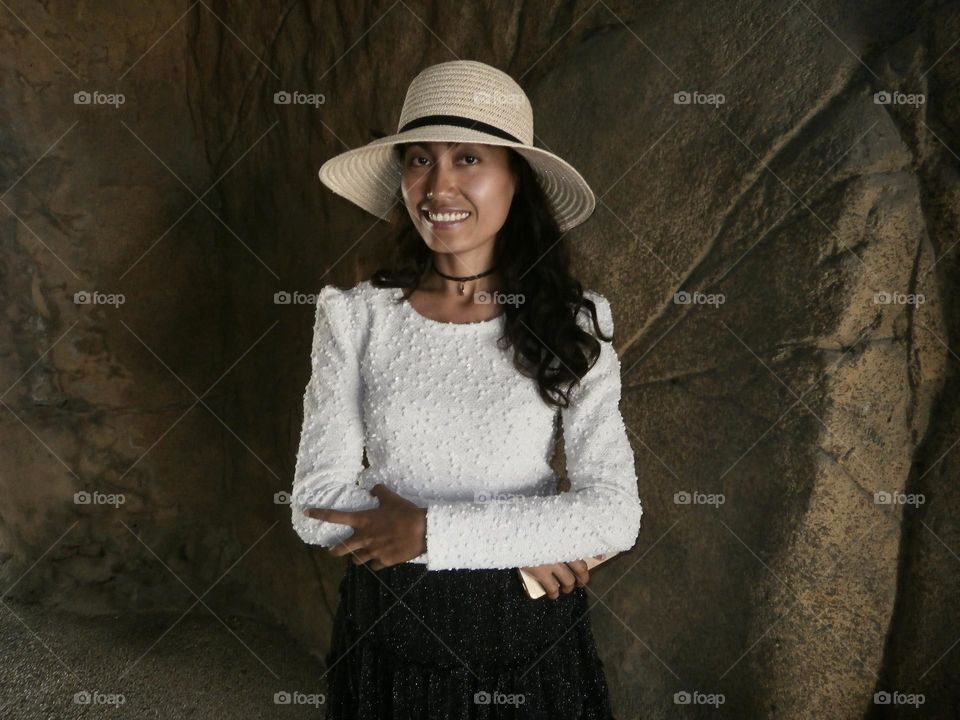 Portrait of a woman wearing a off white hat