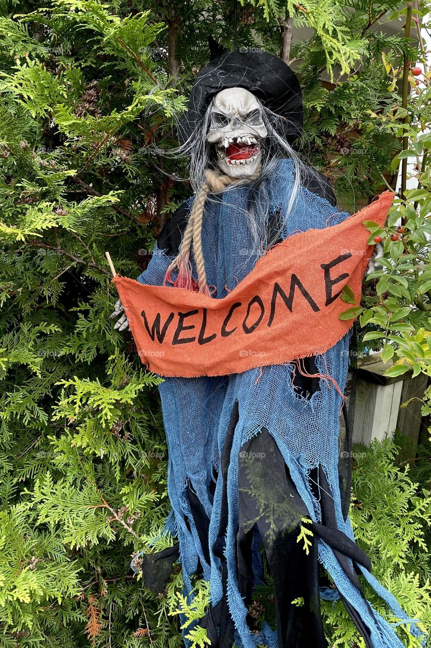 Halloween decorations outdoors, skeleton with welcome sign 