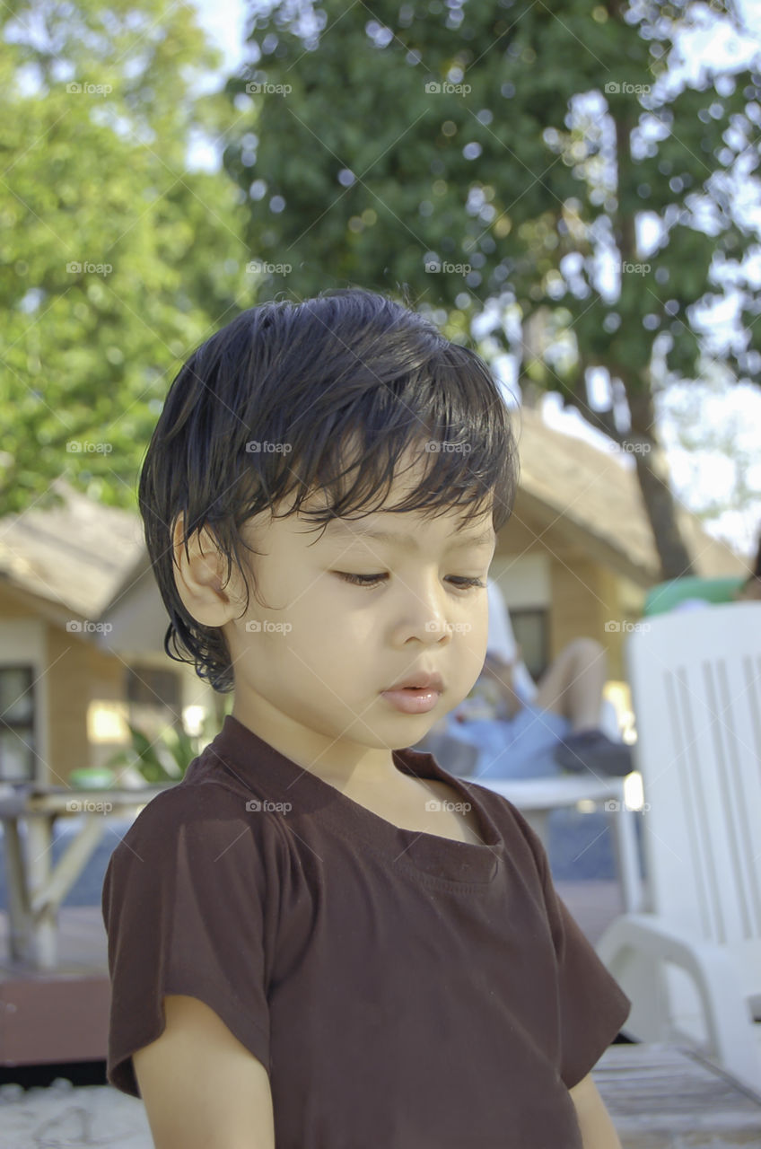 Portrait boy Sitting on the beach, Koh Lipe at Satun in Thailand.