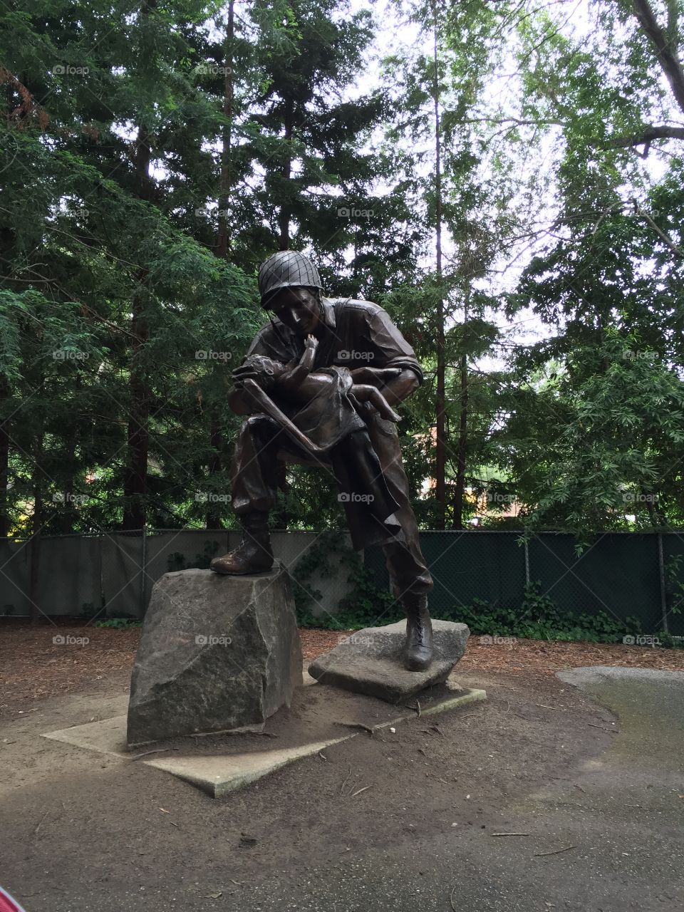 Statue of a fighter fire holding child