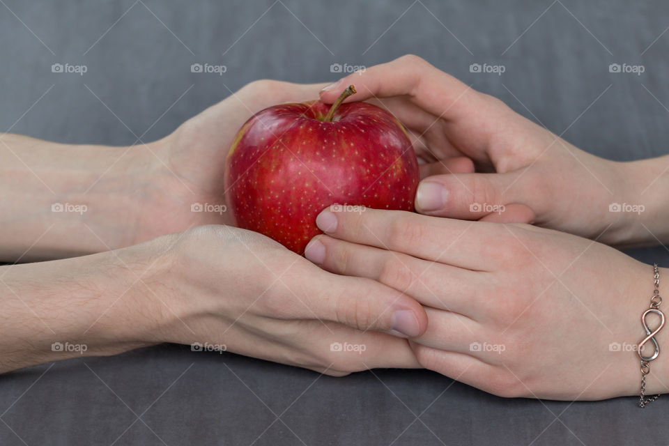 Close-up of holding hand with apple