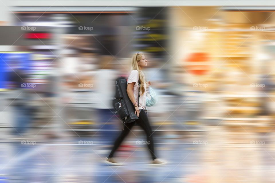 Woman rushing towards departure gates at the airport