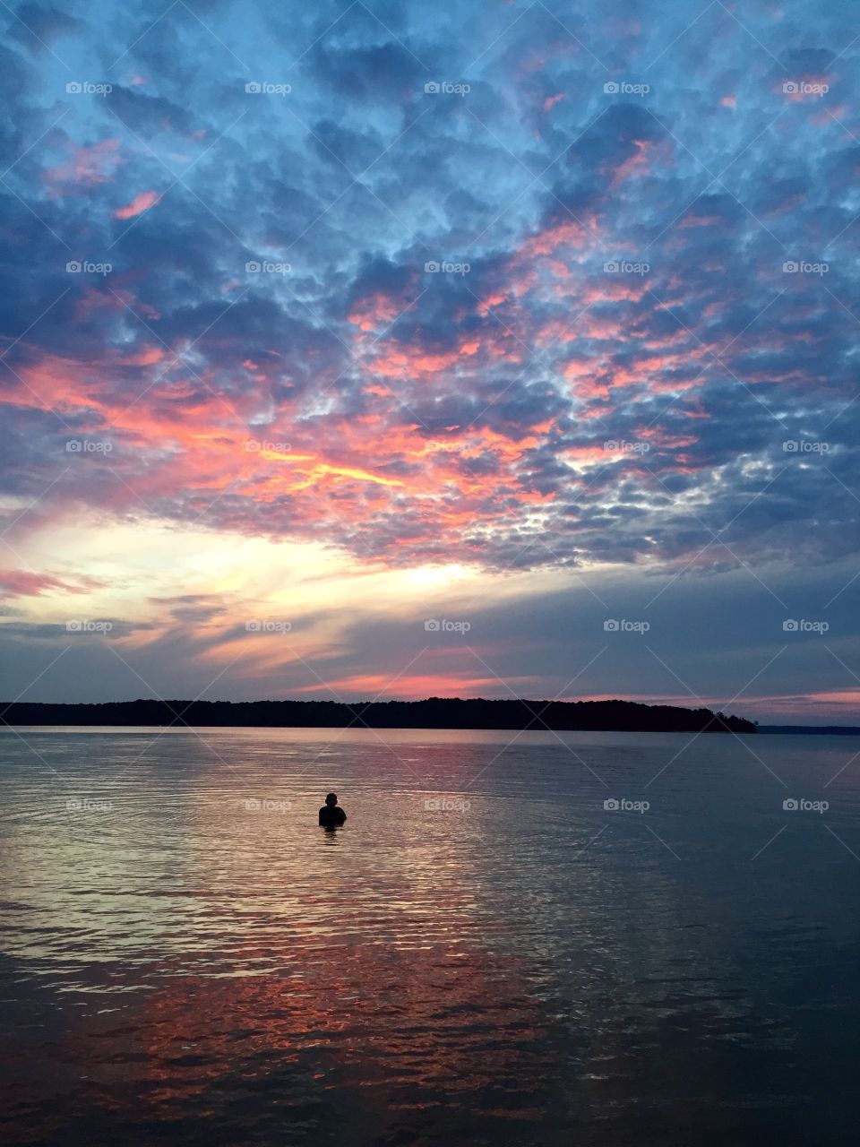 Silhouette of man swimming in sea