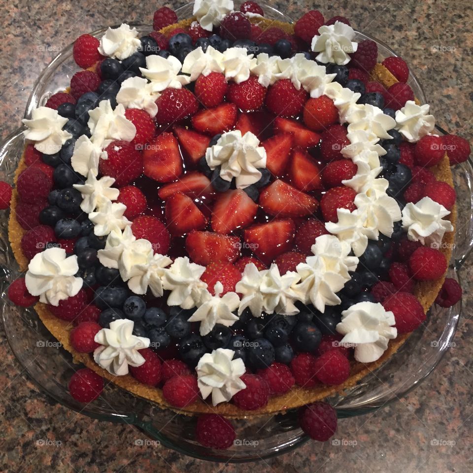 Cake with strawberries, raspberries, blueberries and whipped cream. Fruits cake dessert