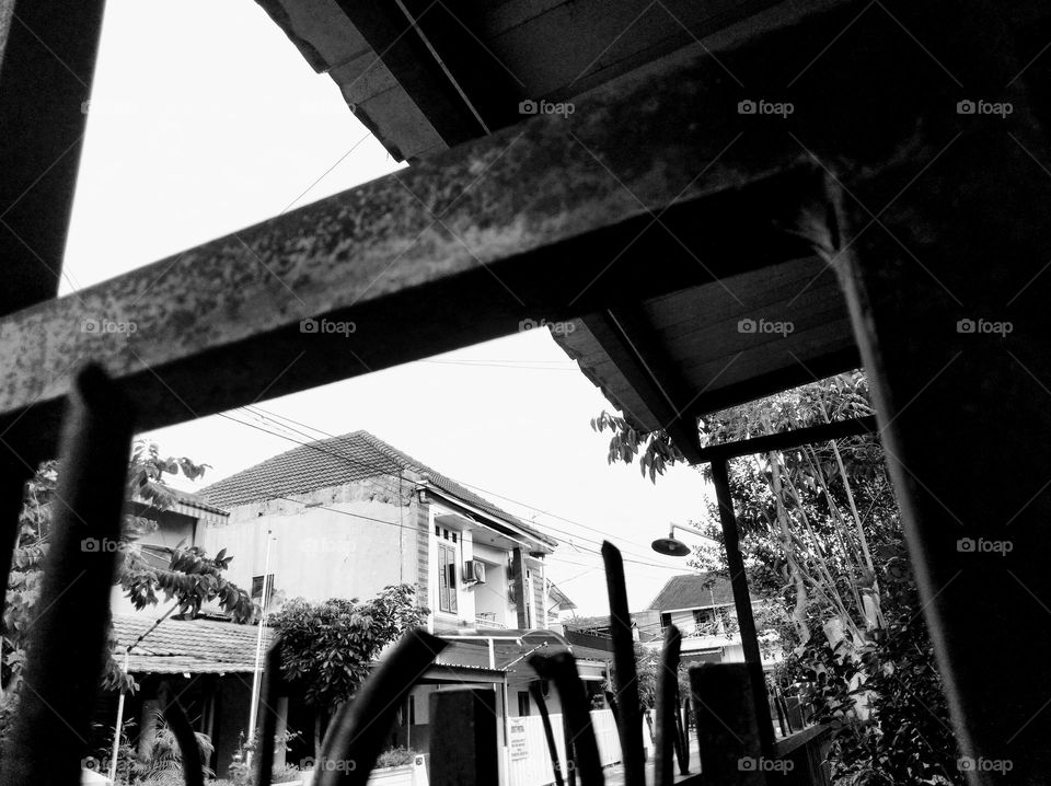 From behind the iron fence