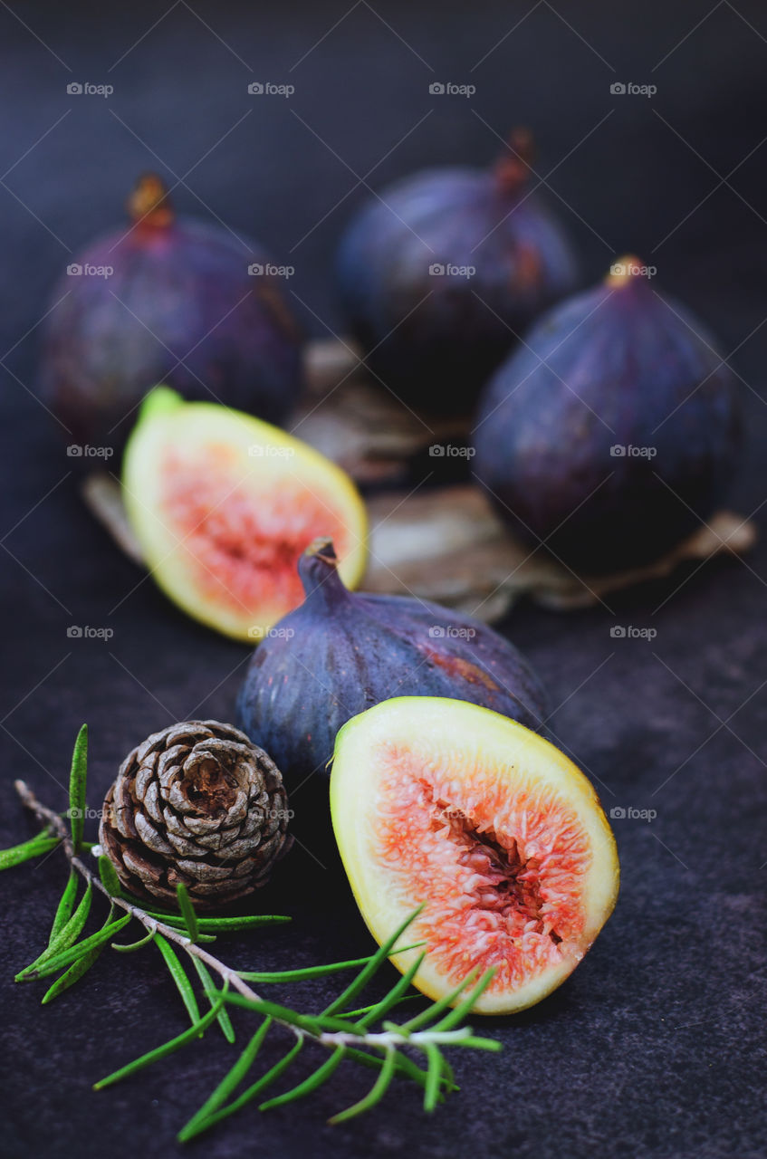 Top view of fresh ripe purple figs on black background close up. Flatlay. Food concept