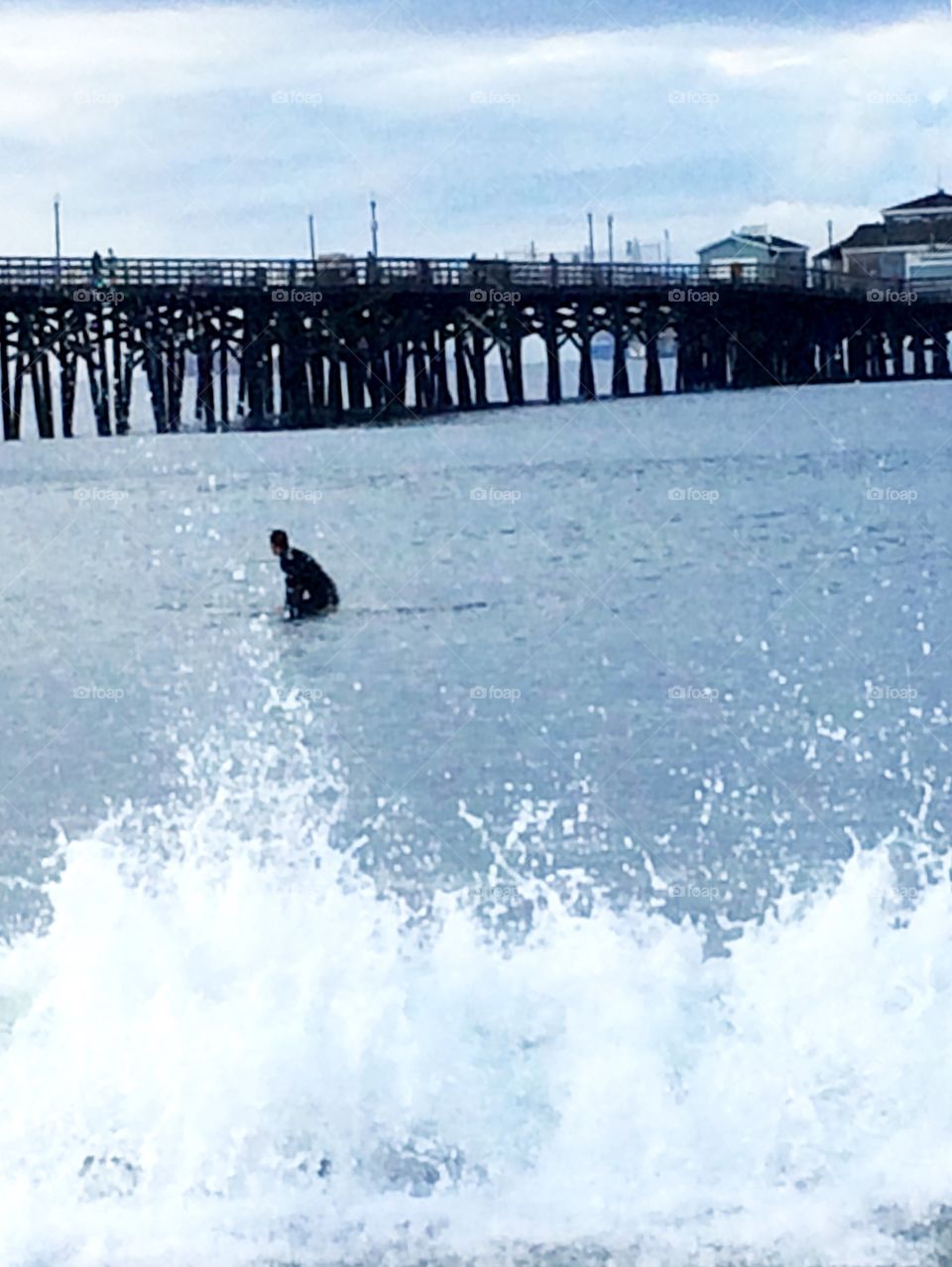 Hoping for a wave. Line surfer hoping for a wave in the storm, Seal Beach, California 