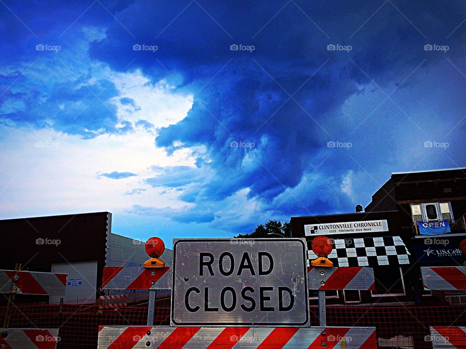 Road Closed Storm Approaching. Beautiful rain clouds behind the construction site 