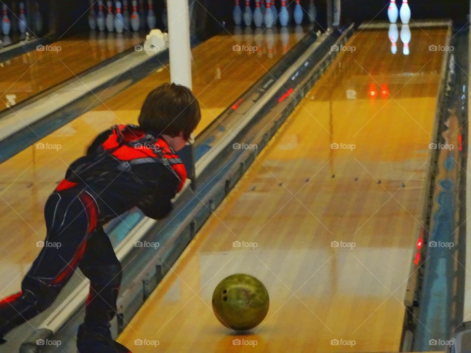 Boy Tossing Bowling Ball
